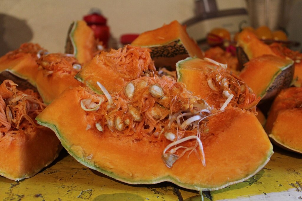 Calabaza cortada en trozos, con las pepitas y las hebras a la vista
